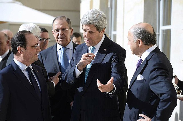 Secretary of State John Kerry confers with French President Francois Hollande (left), Russian Foreign Minister Sergey Lavrov (background) and French Foreign Minister Laurent Fabius during a break Wednesday in Paris in their talks on Ukraine. 