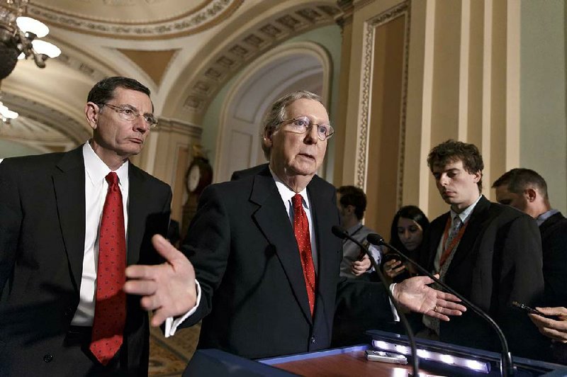 Senate Minority Leader Mitch McConnell, accompanied by Sen. John Barrasso, speaks after Wednesday’s vote blocking Debo Adegbile to lead the Justice Department’s civil-rights division. McConnell had questioned Adegbile’s fitness for the job. 