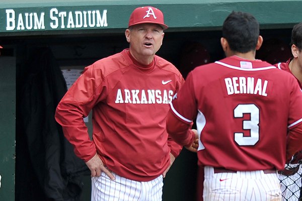Arkansas coach Dave Van Horn talks with Michael Bernal after he was thrown out at home plate during a game Saturday, March 1, 2014 at Baum Stadium in Fayetteville. 