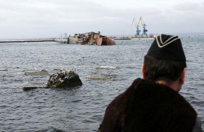The partially sunken Russian vessel Ochakov blocks Ukrainian navy ships Thursday inside Ukraine’s Southern Naval Headquarters in western Crimea after Russian sailors scuttled the decommissioned ship. Russian warships are patrolling just off the Black Sea coast.


