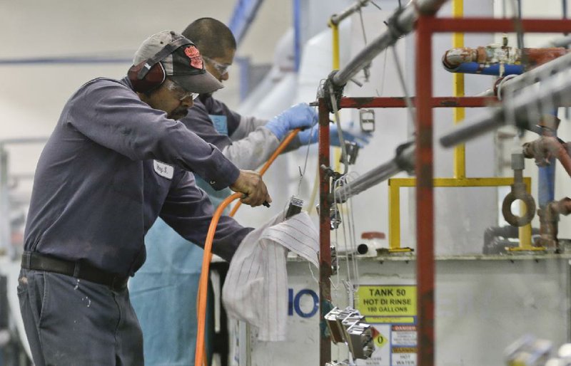 FILE - In this Thursday, Oct. 10, 2013, file photo, employees at Sheffield Platers Inc. work on the factory floor in San Diego. The labor Department releases fourth-quarter productivity data on Thursday, March, 6, 2014. (AP Photo/Lenny Ignelzi, File)