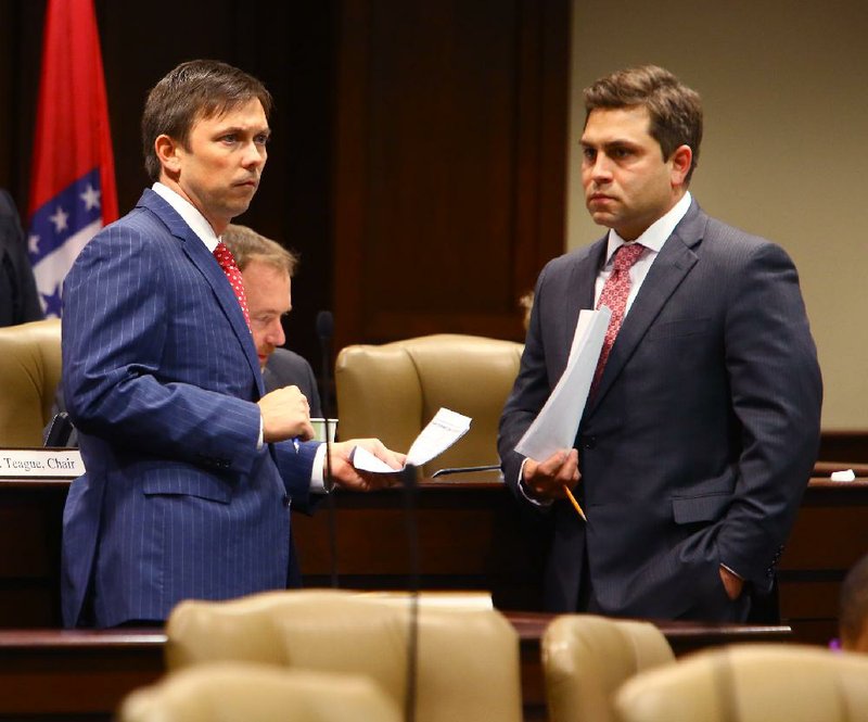 House Speaker Davy Carter, R-Cabot, (left) and Sen. Jonathan Dismang, R-Searcy, confer Thursday before the Joint Budget Committee meeting. The two presented a package containing $21.9 million in proposed spending using the state’s surplus. 