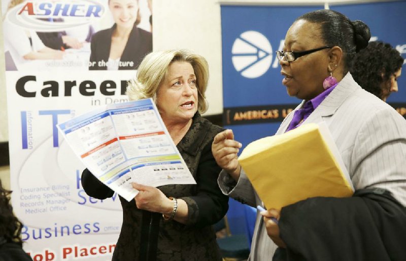 In this Wednesday, Jan. 22, 2014, photo, recruiter Valera Kulow, left, speaks with job seeker Monic Spencer during a career fair in Dallas. The Labor Department releases weekly jobless claims on Thursday, March 5, 2014. (AP Photo/LM Otero, File)