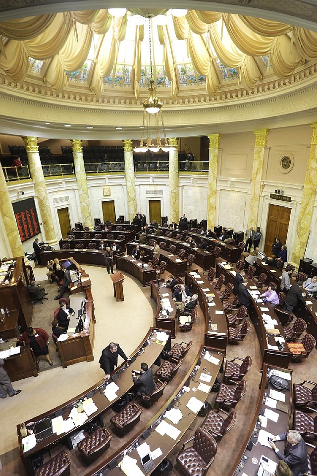 At the state Capitol, the House chamber was nearly empty during a recess Friday. Lawmakers will return Monday to pass the fi scal-2015 budget. 