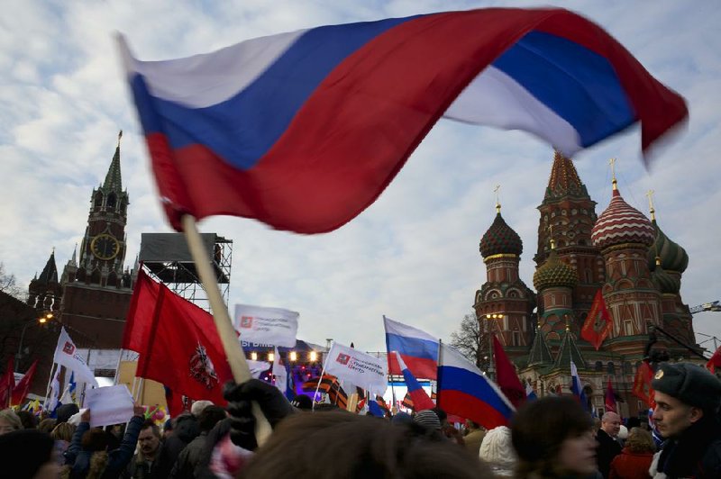 Demonstrators waving Russian flags Friday gather at Red Square in Moscow as Russia rallied support for a Crimean bid to secede from Ukraine. One leader in Russia’s parliament assured Crimean leaders that the region would be welcomed as “an absolutely equal subject of the Russian Federation.” 