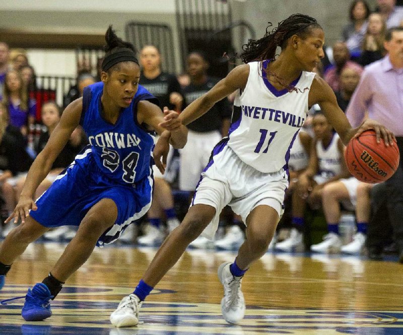 Conway’s Jordan Danberry (left) guards Fayetteville’s Pink Jones during Saturday’s Class 7A state tournament game in Conway. Danberry finished with a game-high 23 points and Conway won 61-51. 