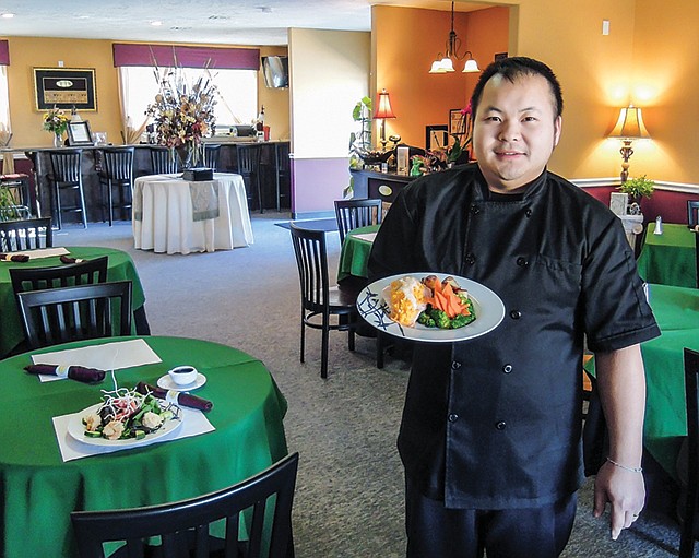Mandalay Asian Cuisine serves popular Chinese and Thai dishes, as well as light American entrees such as steamed salmon stuffed with shrimp and crab meat, as shown by Toua Xiong.