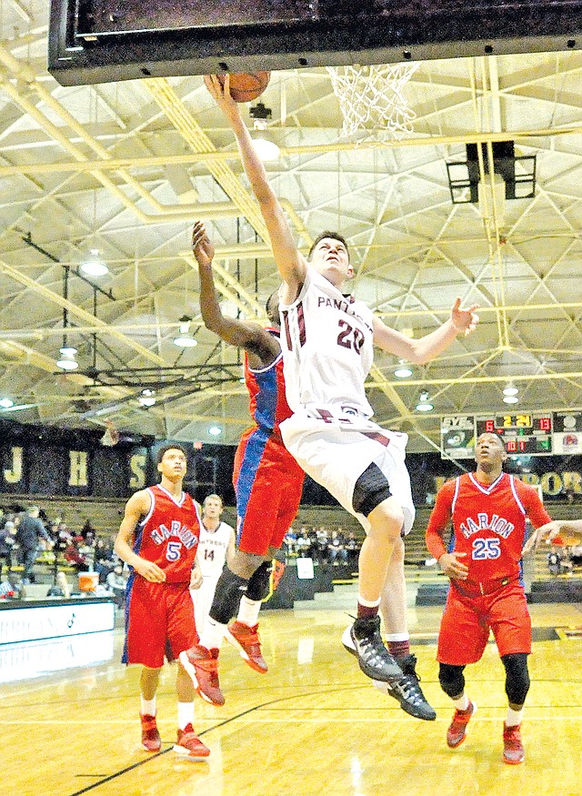 Special to NWA Media Bud Sullins Avery Benson, a Siloam Springs freshman, splits the Marion defense Saturday for a layup during the Panthers&#8217; 52-45 win against the Patriots in the Class 6A State Tournament at Jonesboro.