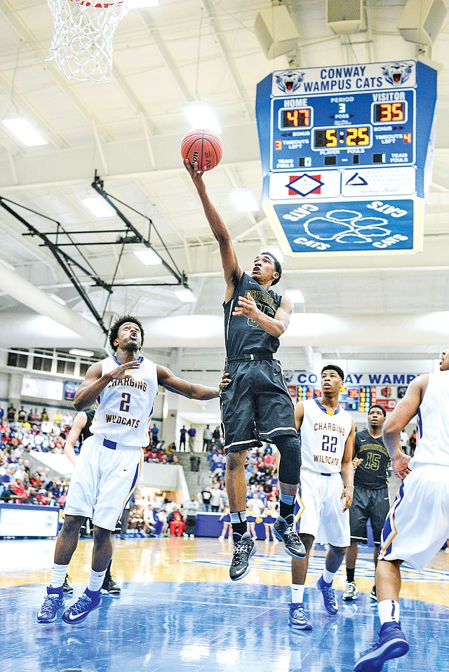 Special to NWA Media Jaison Sterling Malik Monk of Bentonville shoots Monday over North Little Rock's K.J. Hill during the Class 7A state tournament at Buzz Bolding Arena in Conway.