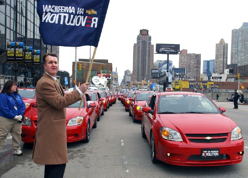 Chevrolet Cobalt SS coupes line up on 11th Avenue outside the Javits Center, the venue for the New York Auto Show, as Chevrolet Assistant Regional Marketing Manager Daniel P. McDonnell waves a flag in this March 2005 file photo. GM announced the recall of more than 780,000 Cobalts and Pontiac G5s on Feb. 13, part of a 1.6 million car recall. 