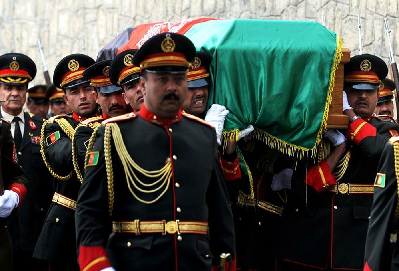 Afghan honor guards carry the coffin of Afghanistan’s Vice President Mohammad Qasim Fahim during his funeral procession Tuesday in Kabul, Afghanistan. Fahim, a leading commander in the alliance that fought the Taliban, died Sunday. He was 57. 