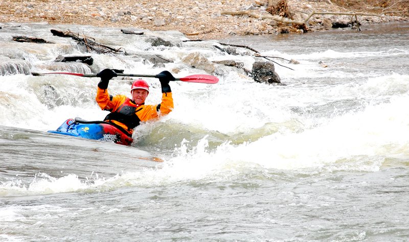 Jeff Della Rosa/Herald-Leader Mike Copeland of Fayetteville surfs in the second of the two drops at Siloam Springs Whitewater Recreation Park on Sunday. For more pictures and a story about what was going on Sunday, see page 6A.