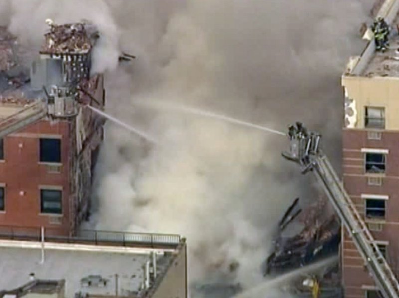 In this image taken from video from WABC, firefighters battle a blaze at the site of a possible explosion and building collapse in the East Harlem neighborhood of New York on Wednesday, March 12, 2014.