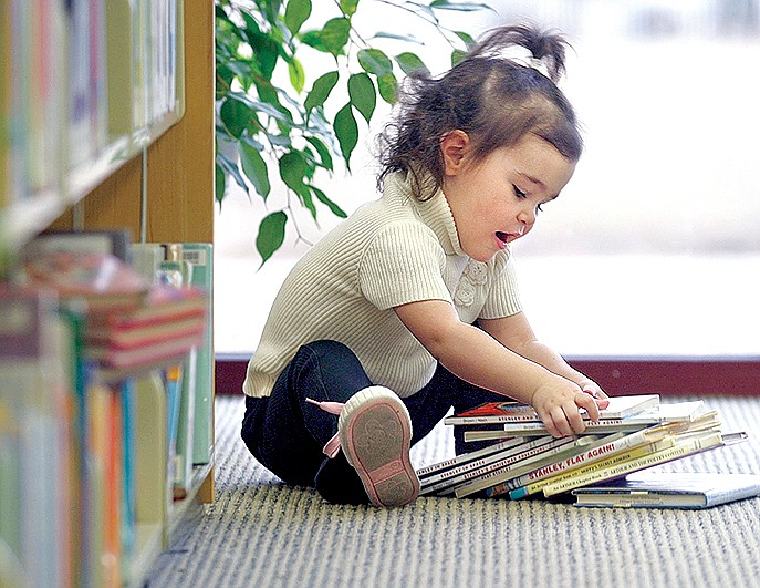 File Photo

A future reader gets acquainted with books at the Springdale Public Library in this NWA Media file photo.