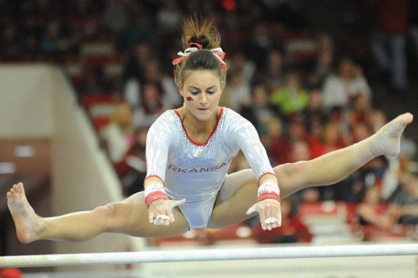 Arkansas' Stephani Canizaro competes in the bars during a meet with Kentucky Friday, Feb. 21, 2014, at Barnhill Arena in Fayetteville.