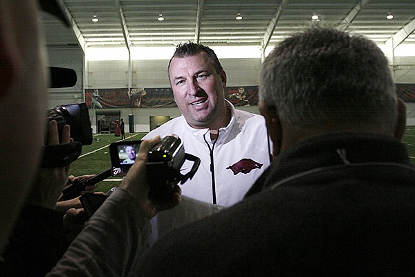 Arkansas head football coach Bret Bielema speaks with reporters Wednesday March 5, 2014 during the 2014 Pro Day at the Walker Family Training Center on the campus of the University of Arkansas in Fayetteville.