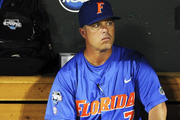 In this June 28, 2011, file photo, Florida coach Kevin O'Sullivan sits in the dugout after South Carolina beat Florida 5-2 in Game 2 of the NCAA baseball College World Series best-of-three finals, to win the title in Omaha, Neb. (AP Photo/Eric Francis)