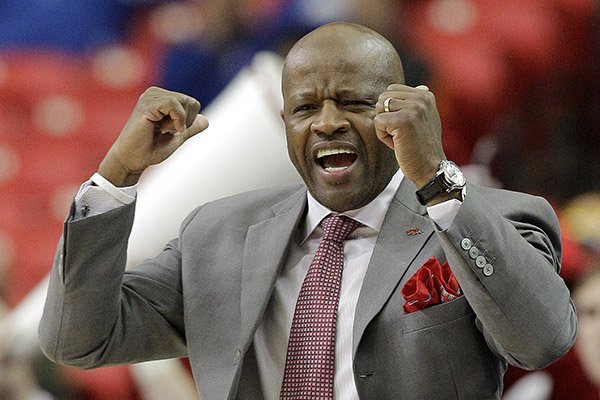 Arkansas head coach Mike Anderson speaks to players against South Carolina during the first half of an NCAA college basketball game in the second round of the Southeastern Conference men's tournament, Thursday, March 13, 2014, in Atlanta. (AP Photo/Steve Helber)