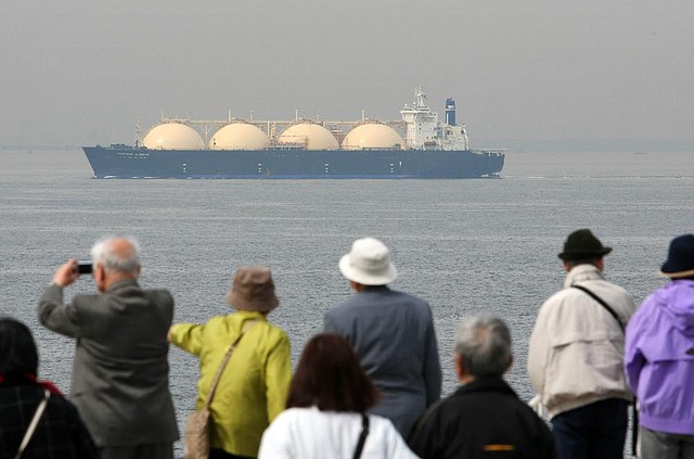 A liquefied natural gas tanker crosses Tokyo Bay in Japan in this 2012 file photo. A lack of facilities to convert natural gas to a liquid for shipping and trade regulations have made it difficult for U.S. companies to export the fuel. 