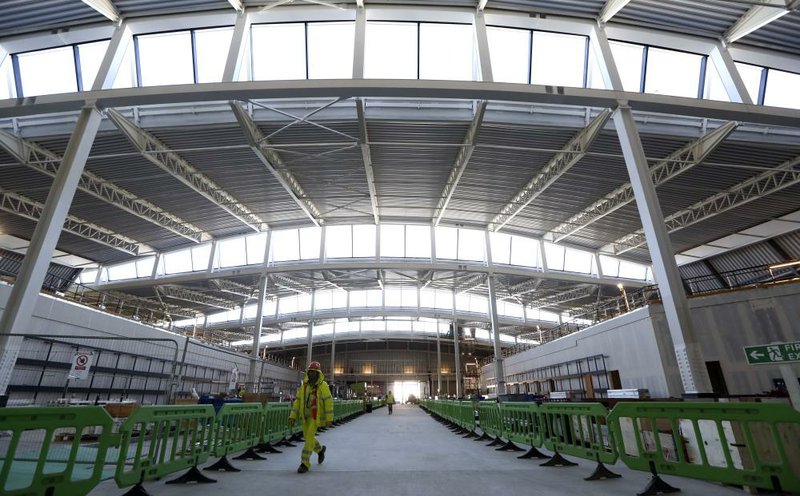 A worker passes through the security checkpoint inside the new Terminal 2 building at Heathrow airport in London during construction work in November. The terminal is set to open June 4 at about 10 percent capacity. 