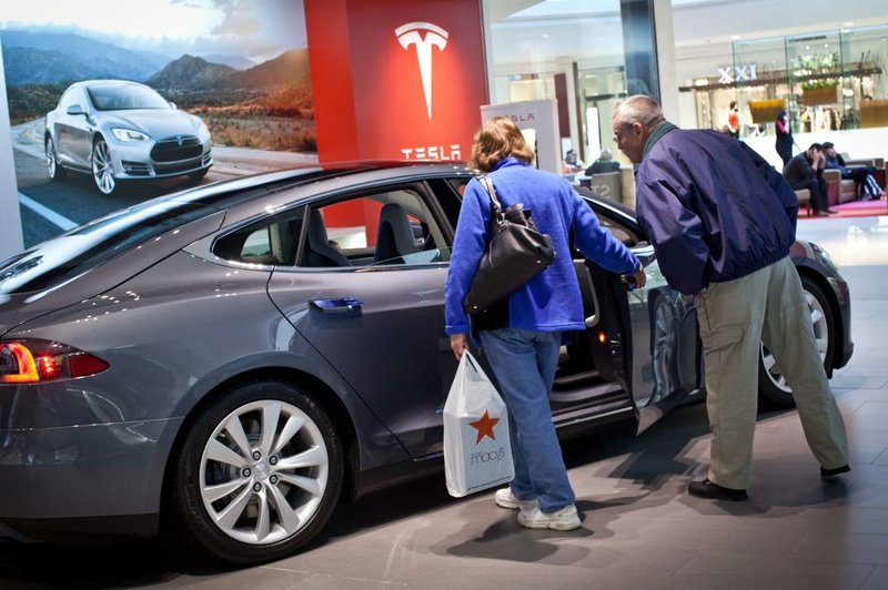 A Tesla Motors Inc. Model S is displayed Wednesday at the Short Hills Mall in Short Hills, N.J., on Wednesday. The state’s Motor Vehicle Commission adopted a regulation Tuesday requiring new car dealers to obtain franchise agreements to receive state licenses, effectively prohibiting Tesla’s direct-sales model. 