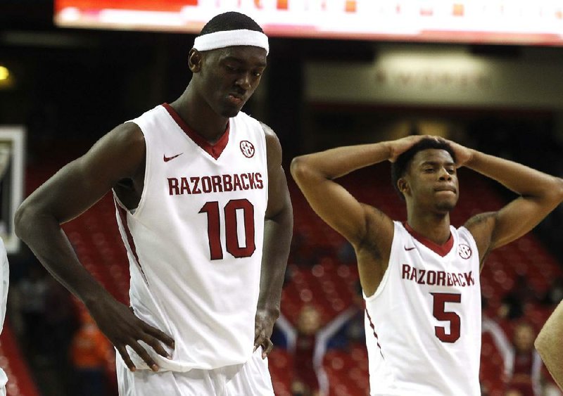 Arkansas Democrat-Gazette/STATON BREIDENTHAL --3/13/14-- Arkansas' Bobby Portis (left) and Anthlon Bell leave the court after their loss to South Carolina Wednesday following their SEC Tournament game at the Georgia Dome in Atlanta.