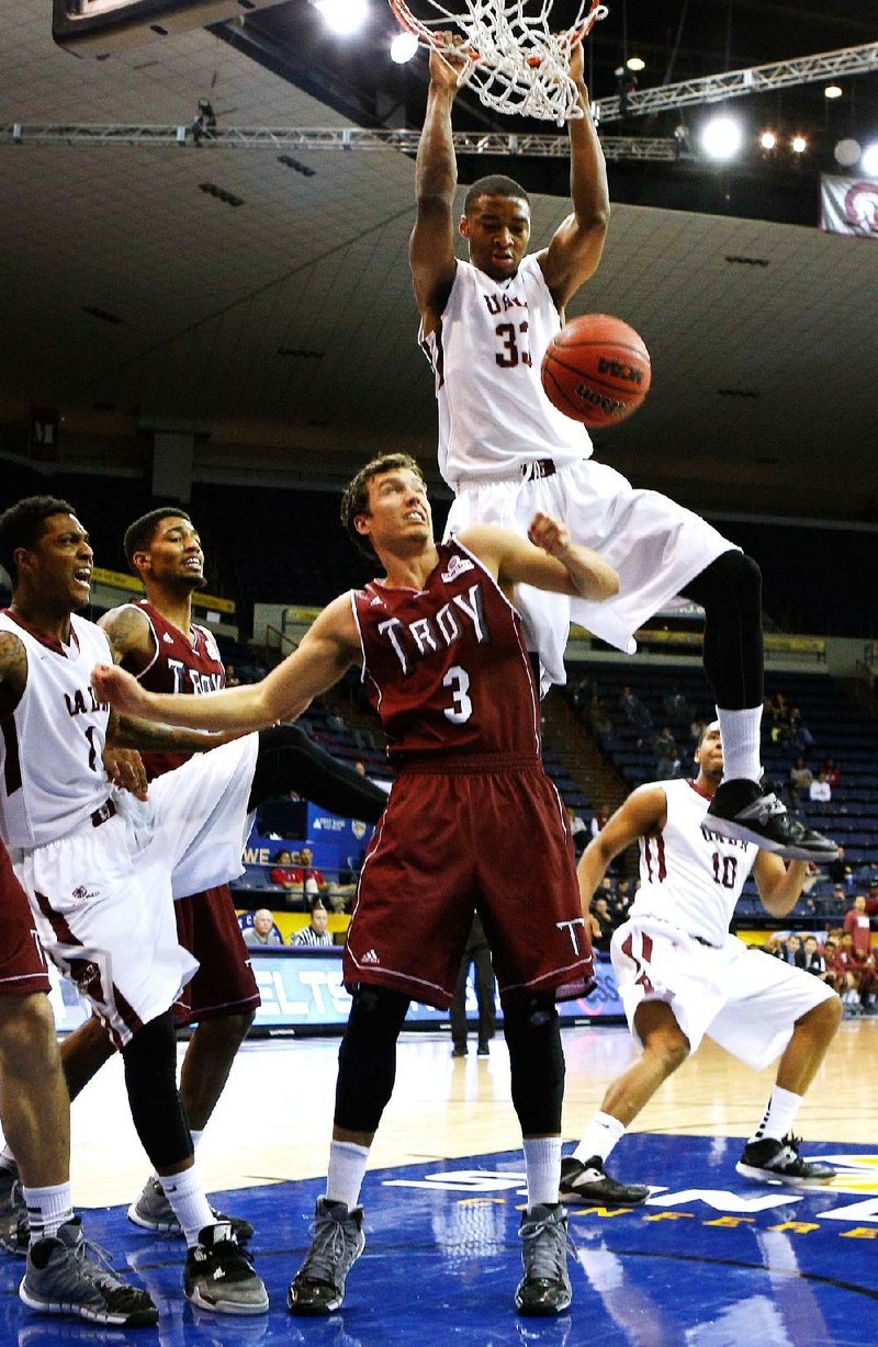 Special to the Arkansas Democrat Gazette/JONATHAN BACHMAN - 03/13/2014 -  UALR forward James White (33) dunks the ball over Troy guard Jeff Mullahey (3) during second half action in the quarterfinal round of the Sunbelt Tournament in New Orleans, March 12, 2014. UALR won 74-61.