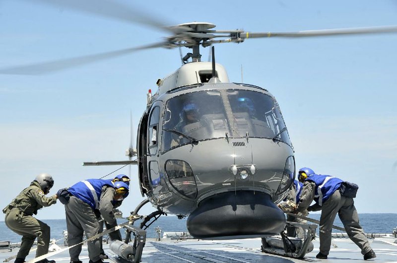 A military helicopter prepares to lift off Thursday to aid in the search for the missing jetliner over the Straits of Malacca, Malaysia, in this photo released by the Royal Malaysian Navy. 