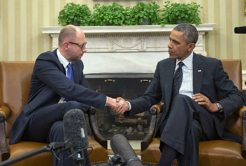 Ukrainian Prime Minister Arseniy Yatsenyuk, meeting Wednesday with President Barack Obama at the White House, said his country “will never surrender” but can still be a “good friend and partner” of Russia. 