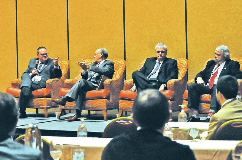 STAFF PHOTO FLIP PUTTHOFF Mayors, from left, Greg Hines of Rogers, Bob McCaslin of Bentonville, Doug Sprouse of Springdale and John Mark Turner of Siloam Springs answer questions Thursday at the John Q. Hammons Center in Rogers.