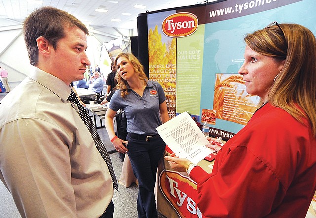 STAFF PHOTO BEN GOFF Donald Daniels, a job seeker and Army veteran, from Siloam Springs, talks Thursday about his resume with Alexa O&#8217;Leary, a military recruiter from Tyson Foods, during the Hiring Our Heroes job fair at the Armed Forces Reserve Center in Bentonville.