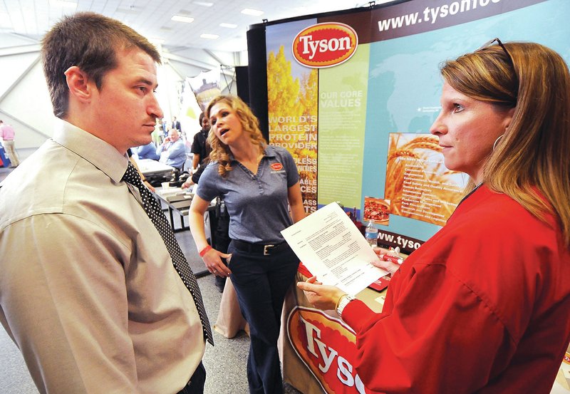 STAFF PHOTO BEN GOFF Donald Daniels, a job seeker and Army veteran, from Siloam Springs, talks Thursday about his resume with Alexa O&#8217;Leary, a military recruiter from Tyson Foods, during the Hiring Our Heroes job fair at the Armed Forces Reserve Center in Bentonville.