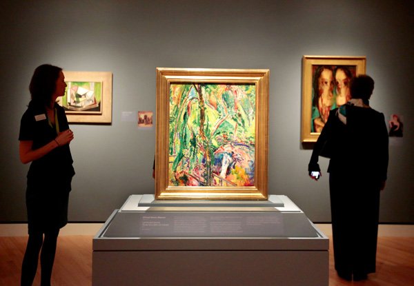 Visitors and staff look over art in the temporary exhibit, The William S. Paley Collection: A Taste for Modernism, during a media preview on Thursday, March 13, 2014, at the Crystal Bridges Museum of American Art in Bentonville. The exhibit opens to the public on Saturday.