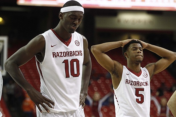 Arkansas' Bobby Portis (left) and Anthlon Bell leave the court after their loss to South Carolina on Thursday, March 13, 2014, following an SEC Tournament game at the Georgia Dome in Atlanta.