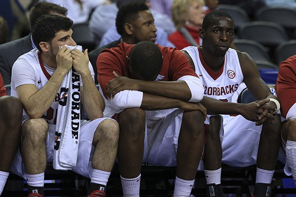 Arkansas' Kikko Haydar (left), Manuale Watkins (middle) and Fred Gulley III watch the closing seconds or their loss to South Carolina at the SEC Tournament at the Georgia Dome in Atlanta.