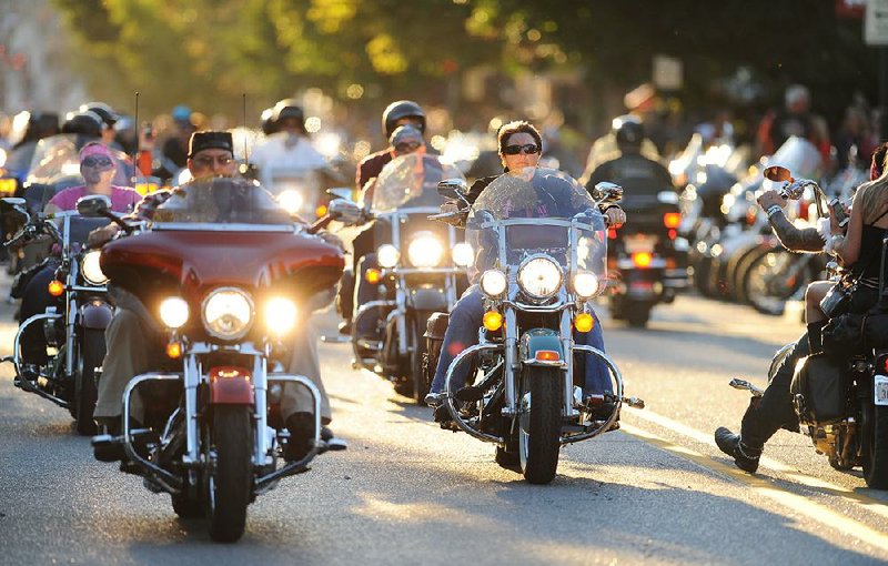 STAFF PHOTO ANDY SHUPE - Riders make their way along Dickson Street Saturday, Sept. 21, 2013, during the 14th annual Bikes, Blues & BBQ motorcycle rally in Fayetteville.