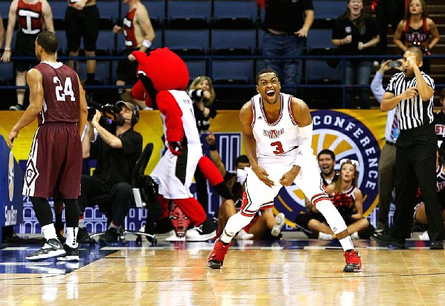 Arkansas State’s Brandon Reed (3) celebrates Friday night after the Red Wolves survived a 116-114 four-overtime victory over UALR to advance to the semifinals of the Sun Belt Tournament. 