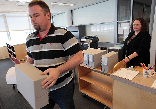 Cary Moriary, an archive technician at the Clinton Presidential Center, distributes some of the 4,000 papers from the Clinton White House years released Friday. 