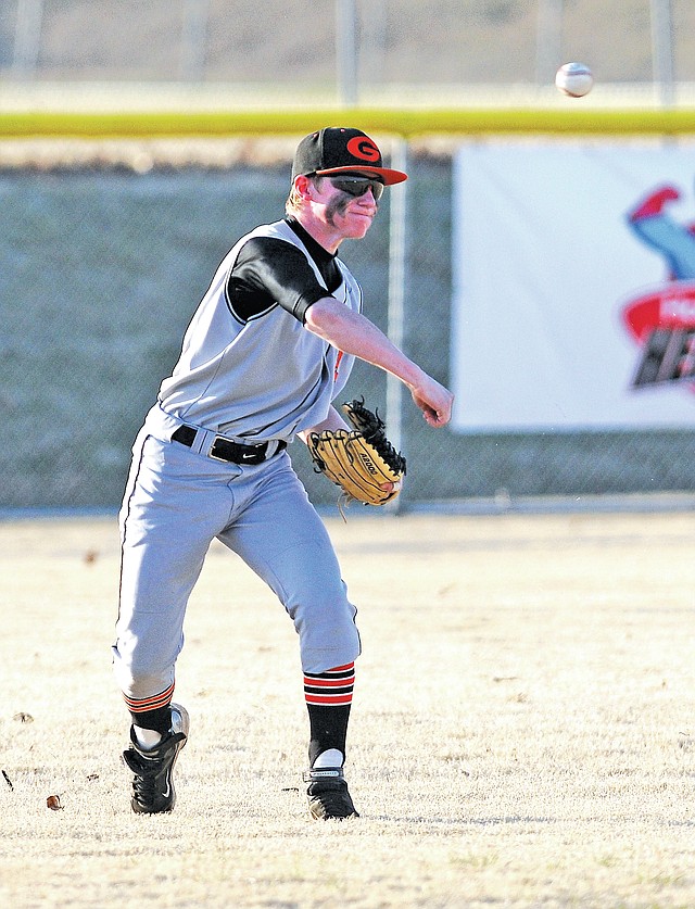  STAFF PHOTO SAMANTHA BAKER &#8226; @NWASAMANTHA Hunter Fine of Gravette throws in a ball hit to left field Friday during the game against Springdale Har-Ber at Randal Tyson Recreational Complex in Springdale.