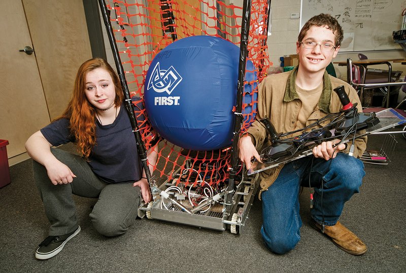 Tenth-graders Dana Smith, left, and Canon Reeves are shown with the robot the Riverview High School team built for the FIRST Robotics Competition. Dana was the human player for the team, and Canon was the driver.