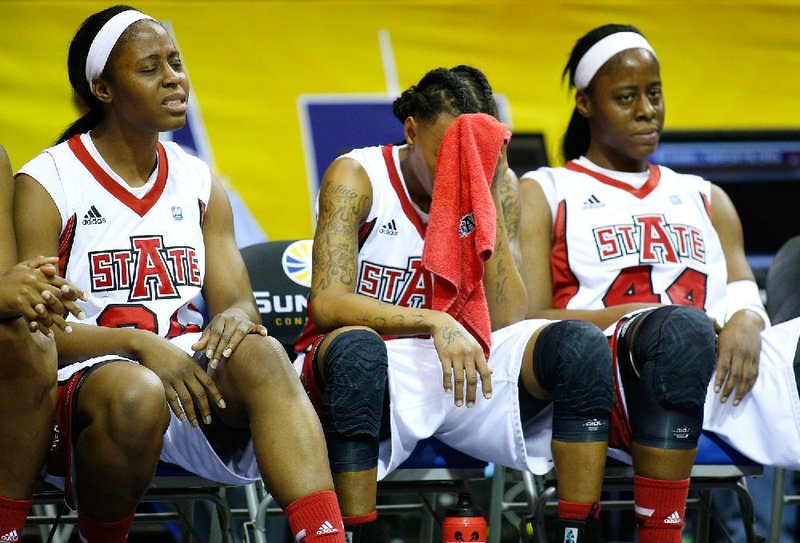 Arkansas State forward Jasmine Hunt (from left), guard Brittney Gill and forward Carlisha Wyatt react late in the second half Saturday against Western Kentucky in the Sun Belt Conference Tournament championship game in New Orleans. 