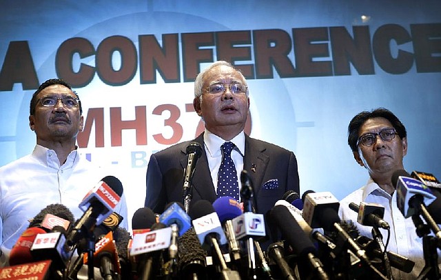 Malaysian Prime Minister Najib Razak (center) said Saturday in Sepang that authorities “have refocused their investigation” on the missing plane’s crew and passengers. 