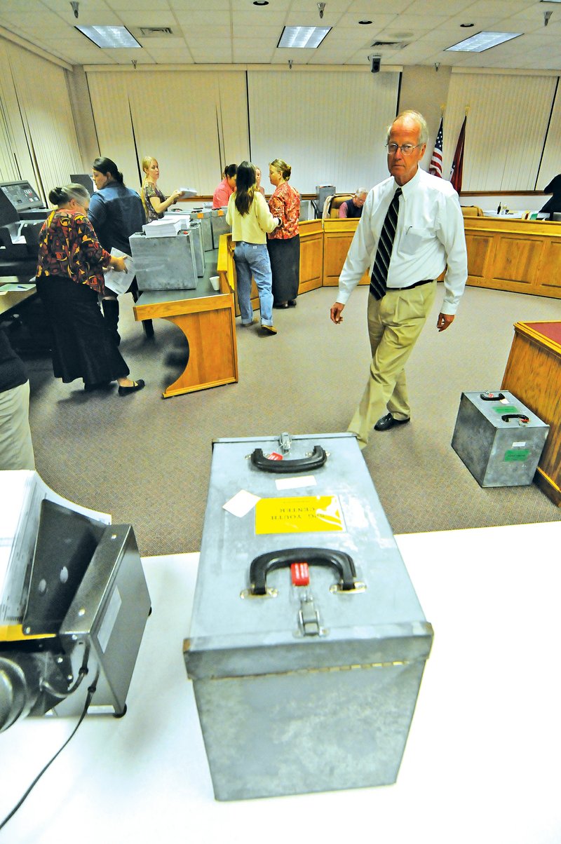 FILE PHOTO John Logan Burrow, who served as chairman of the Washington County Election Commission since 1995, oversees the counting of ballots in the 2010 general election at the Washington County Courthouse. Burrow died unexpectedly from a heart attack last week.