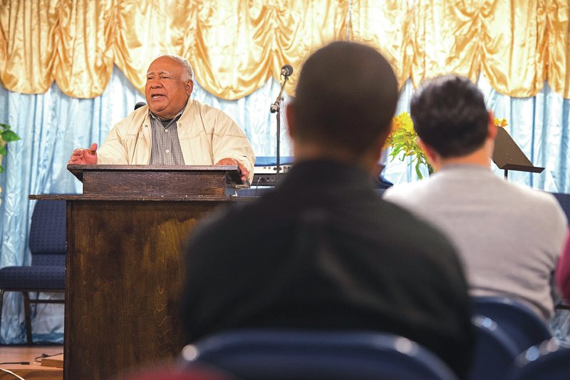 STAFF PHOTO ANTHONY REYES Jose Padilla, pastor at Iglesia Cristiana Pentecostes Ministero El Shaddai, talks to church members Friday, during a service at the church in Springdale. Some members of this church, as well as the church itself, were scammed by Anthony Calderon.