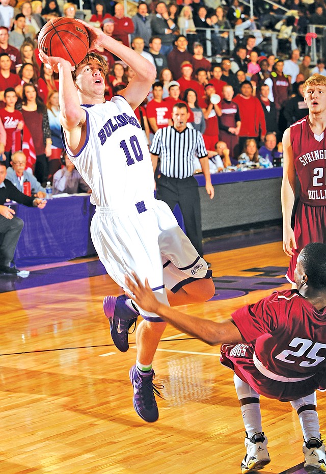 File PHOTO ANDY SHUPE Luke Renner, Fayetteville senior, shoots Jan. 24 as Springdale High junior TreShawn Gause attempts to draw a charge. Renner is one of seven seniors the Bulldogs will have to replace next season.