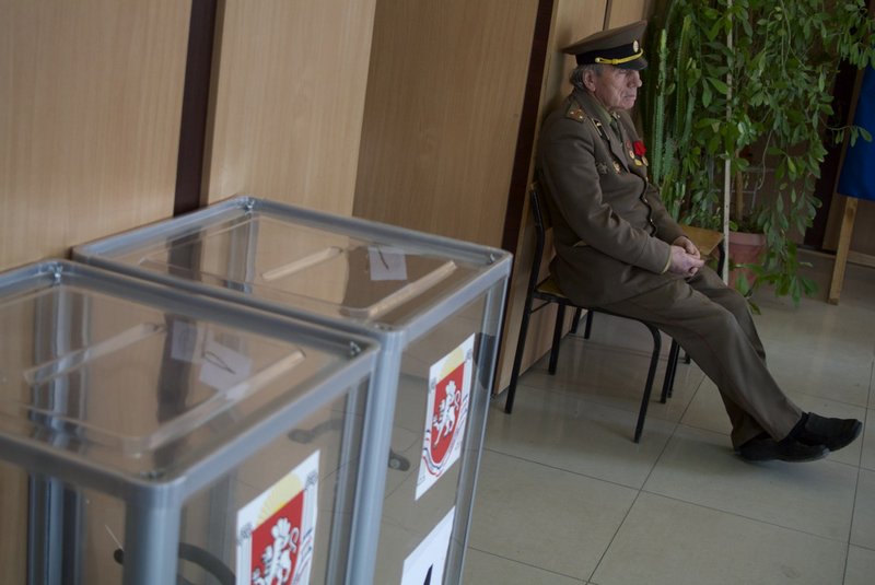 An election observer sits at a polling station in Simferopol, Ukraine, on Sunday, March 16, 2014. Residents of Ukraine's Crimea region are voting in a contentious referendum on whether to split off and seek annexation by Russia. 