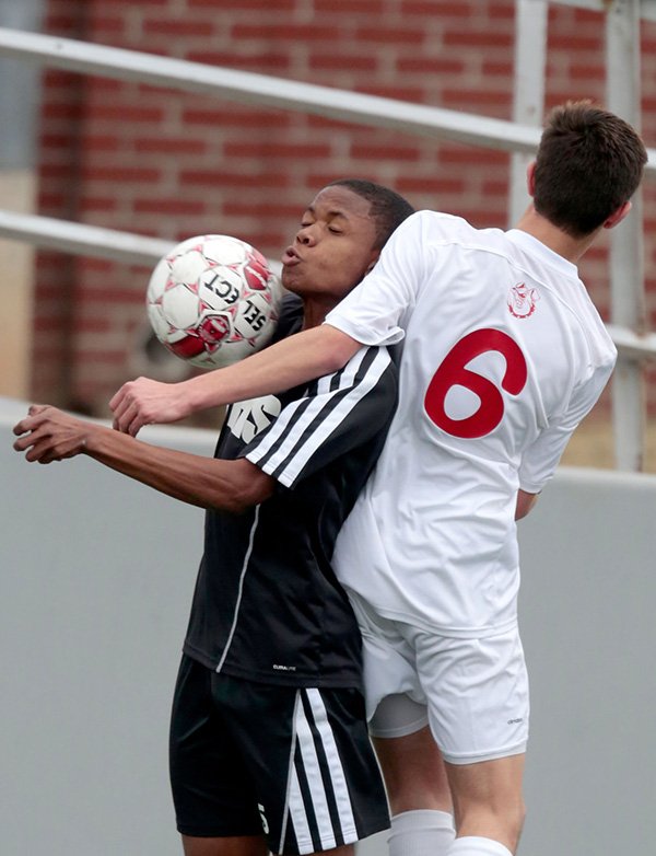     STAFF PHOTO JASON IVESTER 
Tolliver Davis, left, of Bentonville and Springdale junior Pablo Cortes go after a ball in the air during the first half in the championship game of the NWA Showcase tournament on Saturday at Springdale High School.