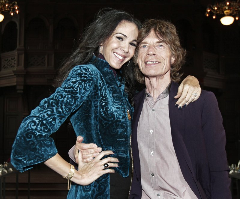 This Feb. 16, 2012, file photo shows singer Mick Jagger, right, with designer L’Wren Scott after her fall 2012 collection was modeled during Fashion Week, in New York. Scott, a fashion designer, was found dead Monday, March 17, 2014, in Manhattan. 
