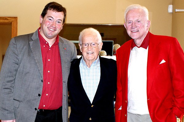 Bob Cheyne, center, is pictured with University of Arkansas associate athletics director Kevin Trainor, left, and former Razorbacks football coach and athletics director Frank Broyles, right, during an event in 2012. 