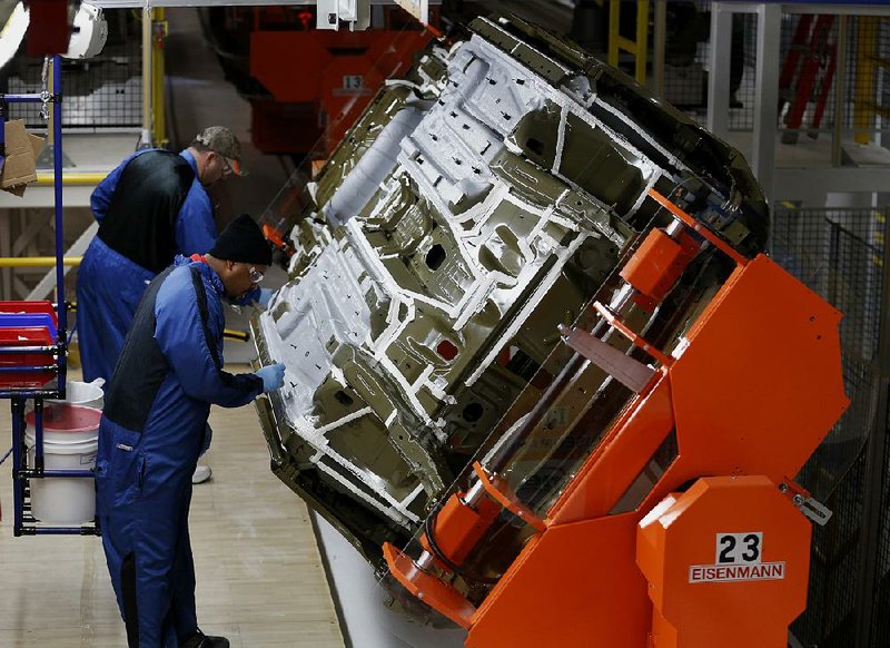 Employees check the under coatings of 2015 Chrysler 200 vehicles in the paint shop at the company's Sterling Heights Assembly Plant in Sterling Heights, Michigan, U.S., on Friday, March 14, 2014. Fiat SpA will add 800 employees in Sterling Heights, Michigan, to support production of the redesigned Chrysler 200, reviving a factory that was almost shuttered following the U.S. automakerís 2009 bankruptcy. Photographer: Jeff Kowalsky/Bloomberg